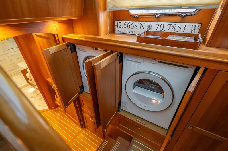 Slide: The Image of Laundry area in 2025 Sabre 58 Salon Express yacht with wooden cabinetry. - 47