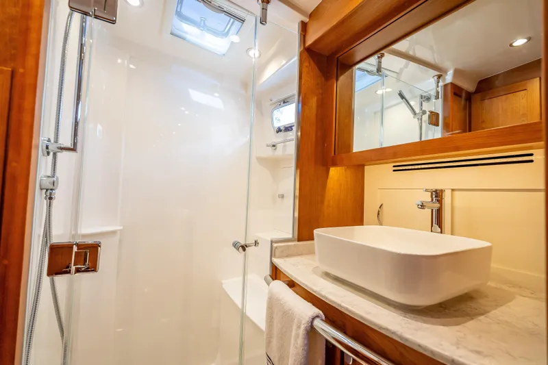 Slide: The Image of Luxurious bathroom in 2025 Sabre 58 Salon Express yacht with modern fixtures and elegant design. - 52