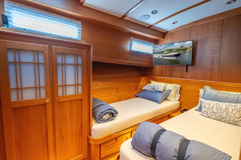 Slide: The Image of Luxurious cabin interior of 2025 Sabre 58 Salon Express yacht with twin beds and TV. - 56