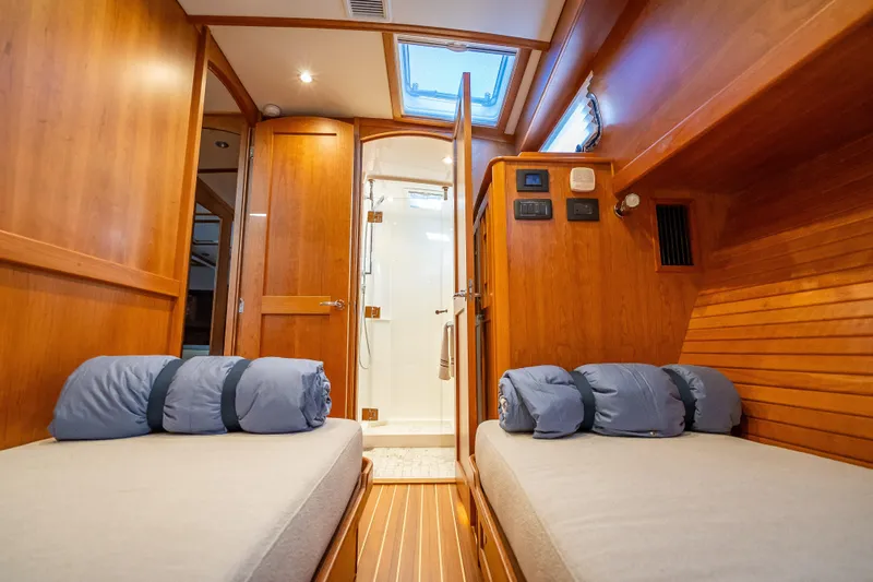 Slide: The Image of Interior of 2025 Sabre 58 Salon Express yacht with twin beds and wooden finish. - 57