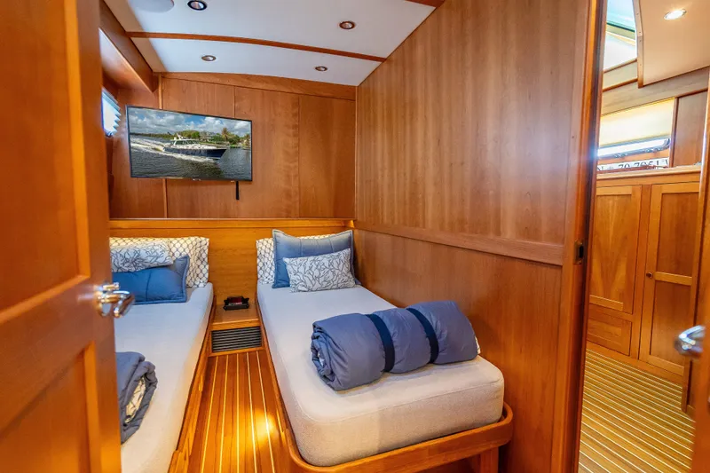 Slide: The Image of Luxurious cabin interior of 2025 Sabre 58 Salon Express yacht with twin beds. - 58