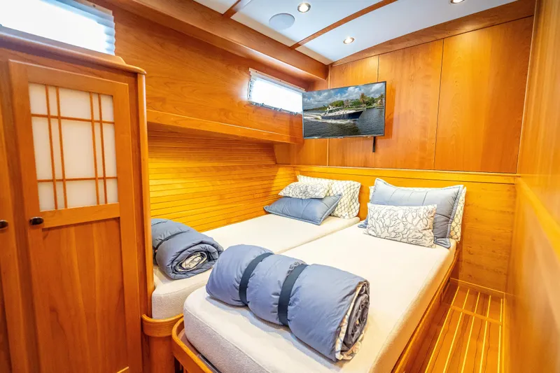 Slide: The Image of Luxurious twin cabin interior of 2025 Sabre 58 Salon Express yacht with wood paneling. - 59