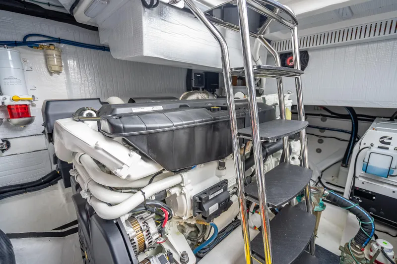 Slide: The Image of Engine room of 2025 Sabre 58 Salon Express with ladder and mechanical components. - 64