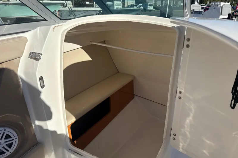 Slide: The Image of 2012 Chaparral 246 SSi boat interior cabin with seating and storage. - 11