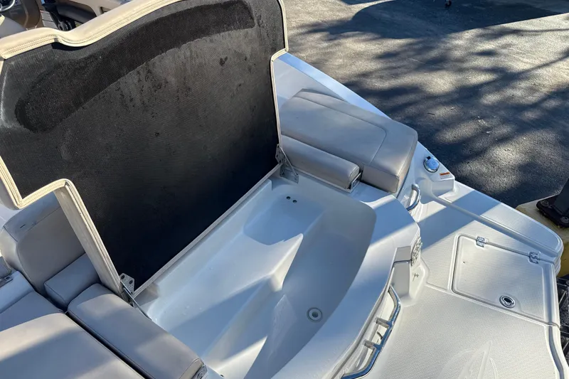 Slide: The Image of 2012 Chaparral 246 SSi boat interior with open storage compartment and seating. - 12