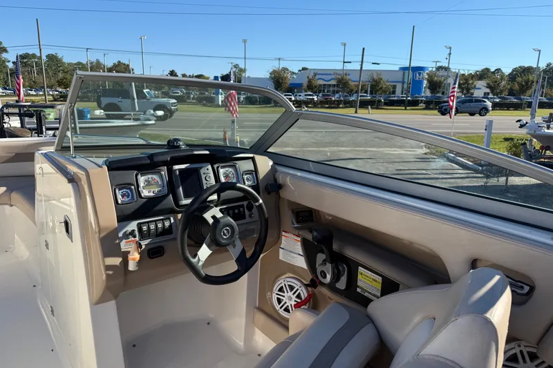 Slide: The Image of 2012 Chaparral 246 SSi boat interior with steering wheel and dashboard controls. - 5