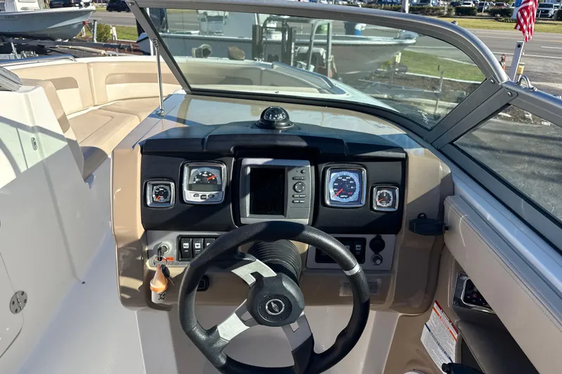 Slide: The Image of 2012 Chaparral 246 SSi boat dashboard with steering wheel and gauges. - 6