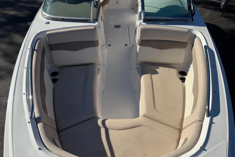 Slide: The Image of 2012 Chaparral 246 SSi boat interior with beige seating and cup holders. - 8