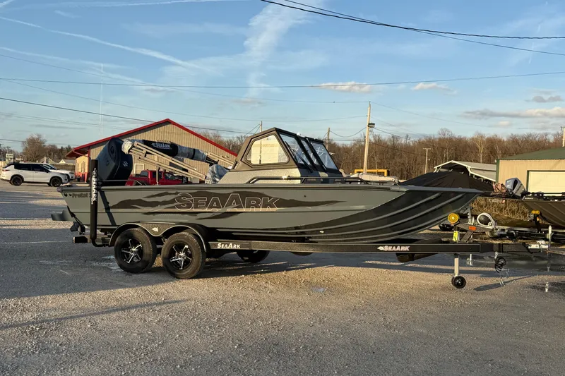 Slide: The Image of 2026 SeaArk ProCat 200 boat on trailer, parked outdoors under clear sky. - 5