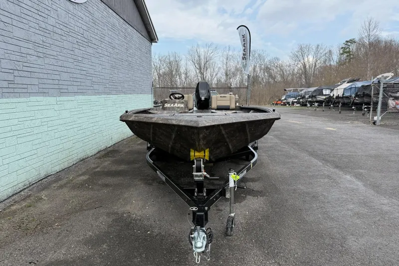 Slide: The Image of 2026 SeaArk Phantom 20XV boat on trailer, parked outdoors near a building. - 3