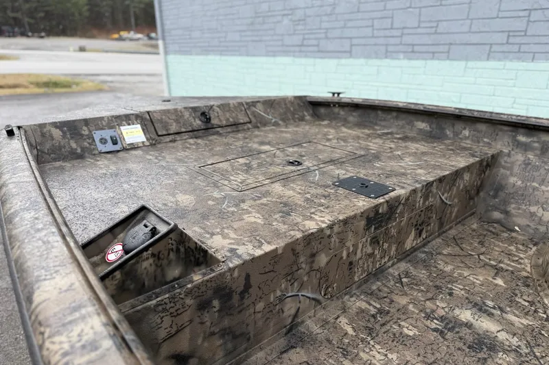 Slide: The Image of 2026 SeaArk Phantom 20XV boat interior with camouflage design, showcasing storage compartments. - 6