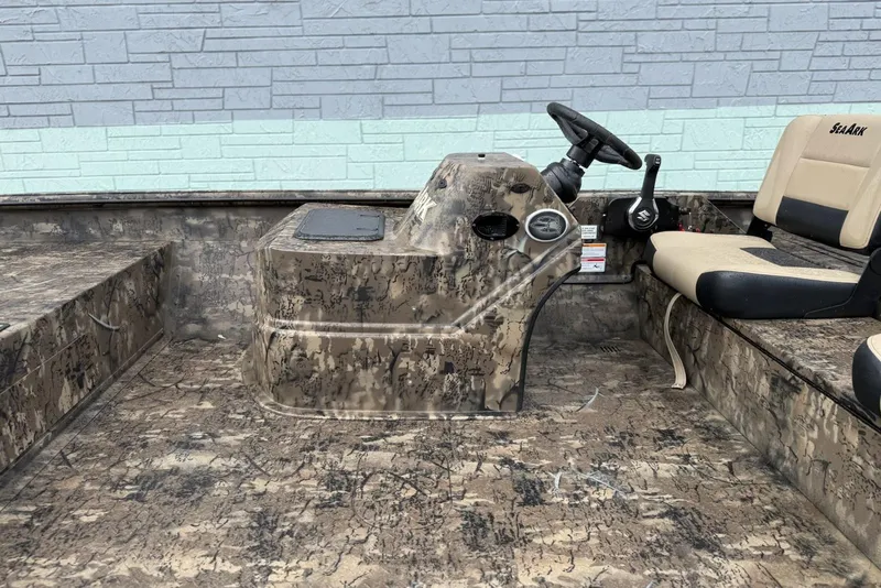 Slide: The Image of 2026 SeaArk Phantom 20XV boat interior with camouflage design and steering console. - 8