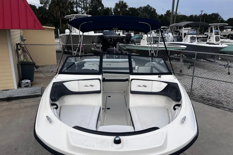 Slide: The Image of 2018 Sea Ray SPX 190 Outboard boat with seating, parked at a marina. - 12