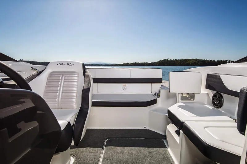 Slide: The Image of Manufacturer Provided Image: 2018 Sea Ray SPX 190 OB boat interior with white seating and lake view. - 5