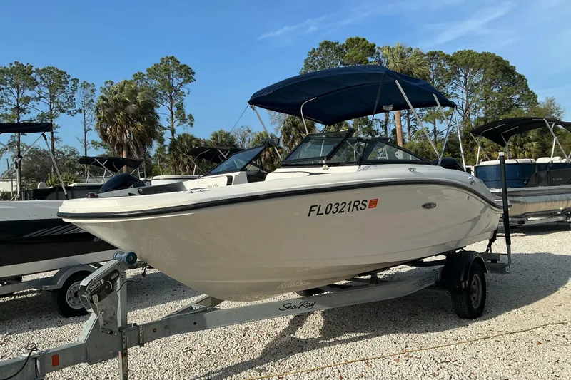 Slide: The Image of 2018 Sea Ray SPX 190 Outboard boat on trailer, parked outdoors under blue sky. - 7
