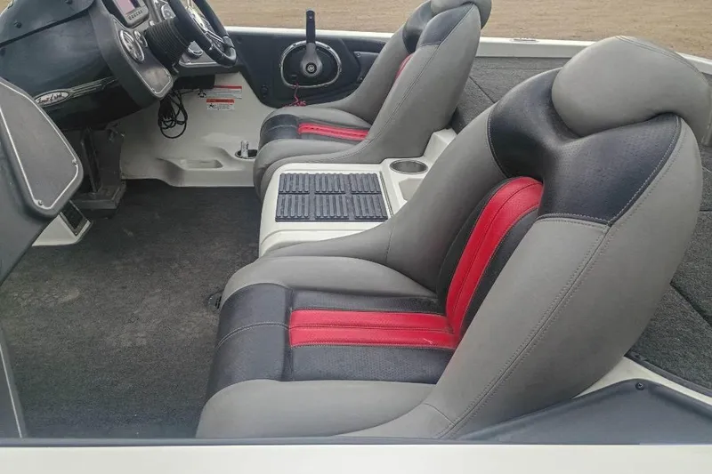 Slide: The Image of 2010 Ranger Z521 boat interior with gray and red seats, steering wheel, and dashboard. - 4
