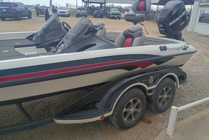 Slide: The Image of 2010 Ranger Z521 boat with Mercury engine on a trailer in a parking lot. - 5