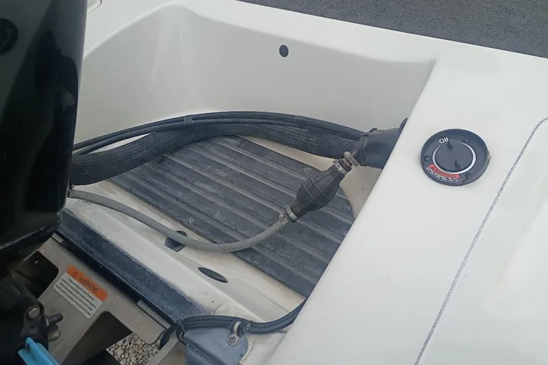 Slide: The Image of 2010 Ranger Z521 boat engine compartment with fuel line and oil cap. - 9