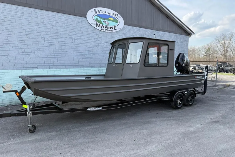 The Image of 2026 SeaArk 2472 CUB boat on trailer outside Water Work Marine building. - 0
