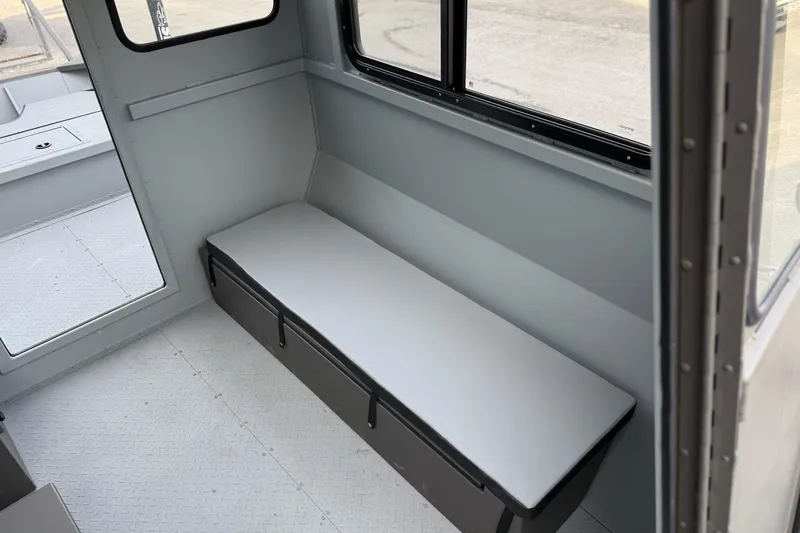 Slide: The Image of Interior of 2026 SeaArk 2472 CUB boat with bench seating and storage. - 11