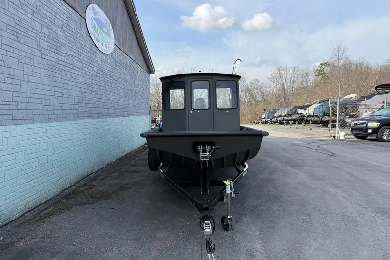 Slide: The Image of 2026 SeaArk 2472 CUB boat on trailer, parked outside a marine dealership. - 3