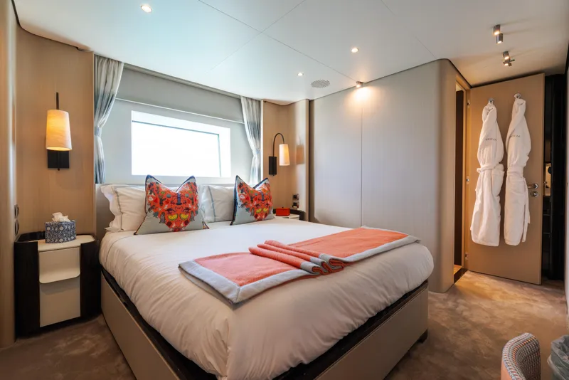 Slide: The Image of Luxurious bedroom interior on 2023 Azimut Grande 32M yacht, featuring elegant decor and plush bedding. - 13