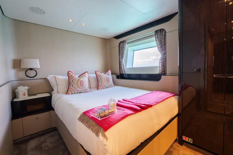 Slide: The Image of Luxurious bedroom interior of 2023 Azimut Grande 32M yacht with elegant decor and window view. - 16