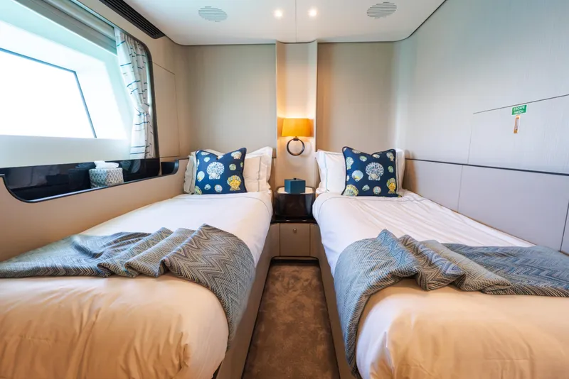 Slide: The Image of Luxurious twin bedroom on 2023 Azimut Grande 32M yacht, featuring elegant decor and cozy bedding. - 17