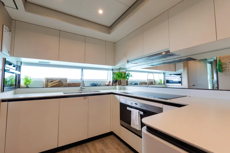 Slide: The Image of Modern kitchen interior on 2023 Azimut Grande 32M yacht, featuring sleek cabinetry and appliances. - 23