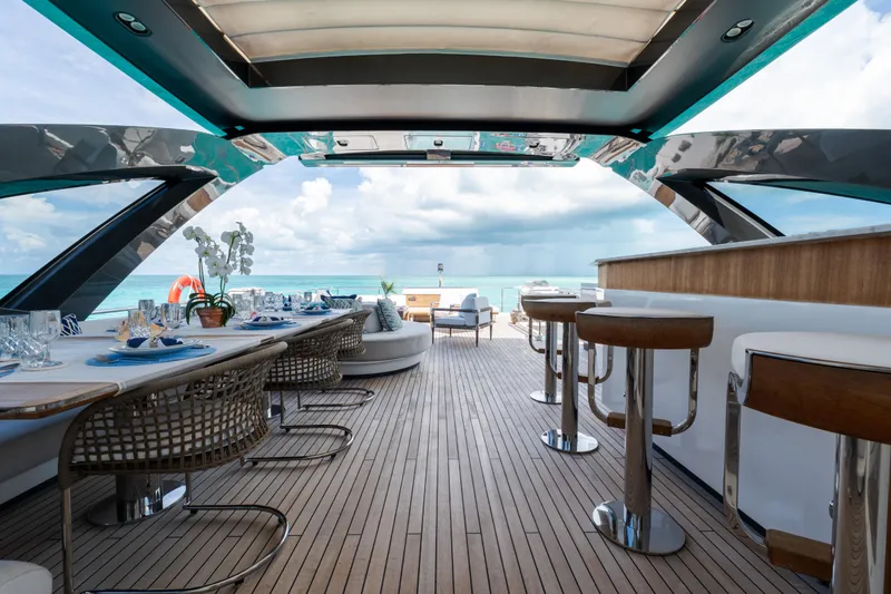 Slide: The Image of Luxurious deck of 2023 Azimut Grande 32M yacht with elegant dining and bar area. - 27