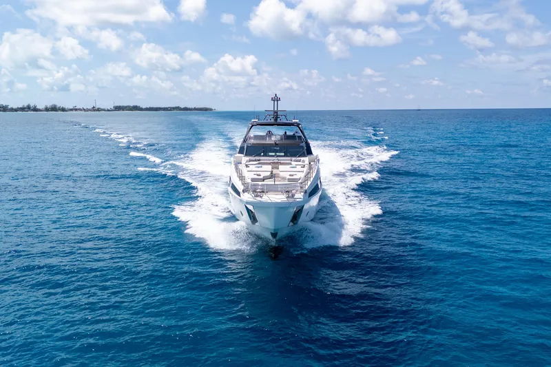 Slide: The Image of 2023 Azimut Grande 32M yacht cruising on clear blue ocean under a sunny sky. - 42