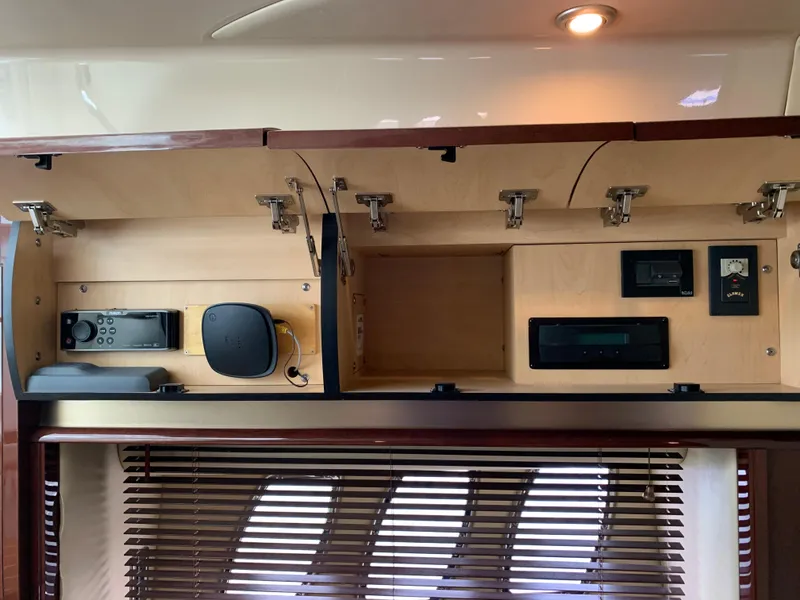 Slide: The Image of Interior of 2007 Sea Ray 52 Sundancer with cabinets and electronics. - 14