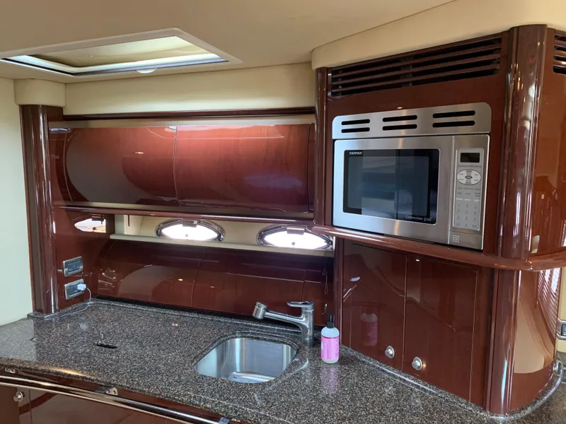 Slide: The Image of Interior of Sea Ray 52 Sundancer yacht, kitchen with microwave, sink, and cabinets. - 20