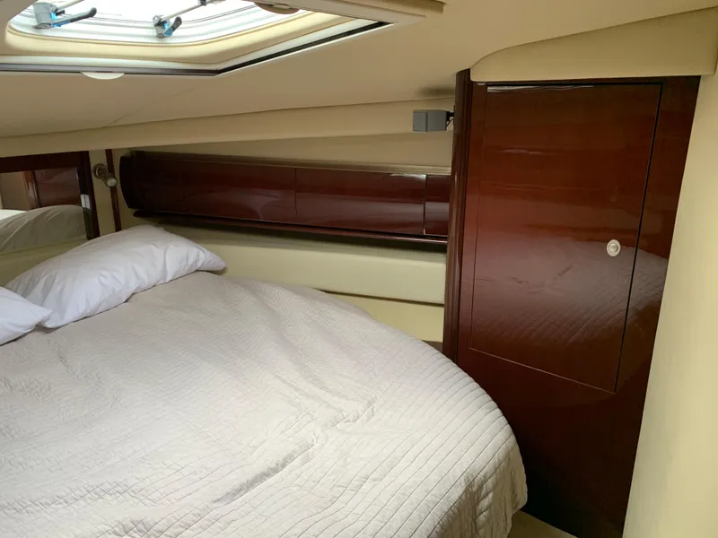 Slide: The Image of Interior of 2007 Sea Ray 52 Sundancer with bed and wood paneling. - 31