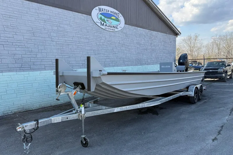 The Image of 2026 SeaArk 2472 Workhorse boat on trailer at Water Worx Marine dealership. - 0