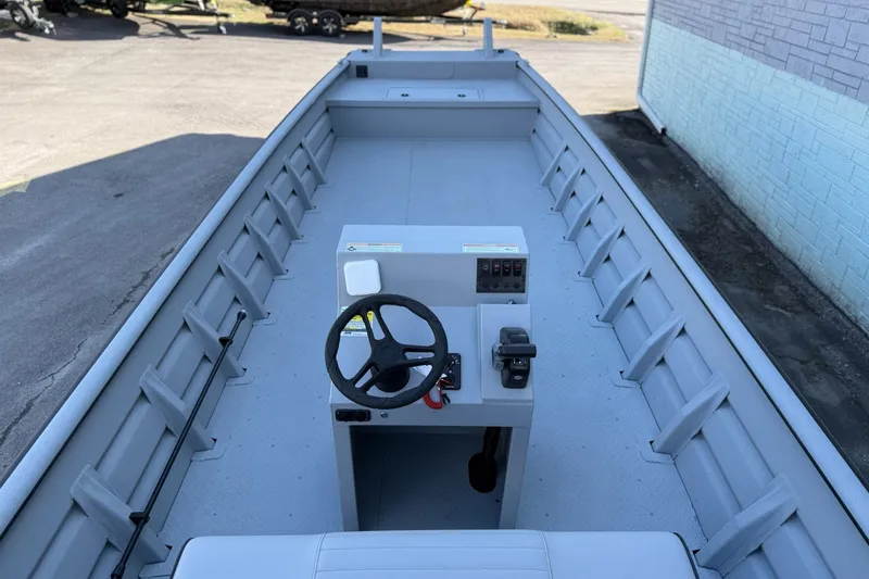 Slide: The Image of 2026 SeaArk 2472 Workhorse boat interior with steering console and spacious deck. - 8