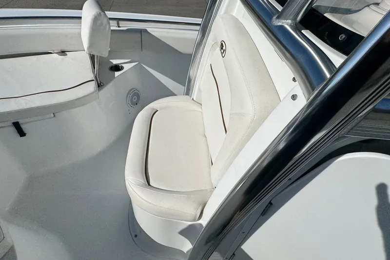 Slide: The Image of 2023 Sea Hunt Ultra 234 boat interior with white cushioned seating. - 11