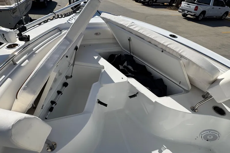 Slide: The Image of 2023 Sea Hunt Ultra 234 boat interior with open storage compartments and seating. - 13