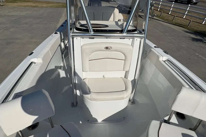Slide: The Image of 2023 Sea Hunt Ultra 234 boat interior with white seating and console. - 15