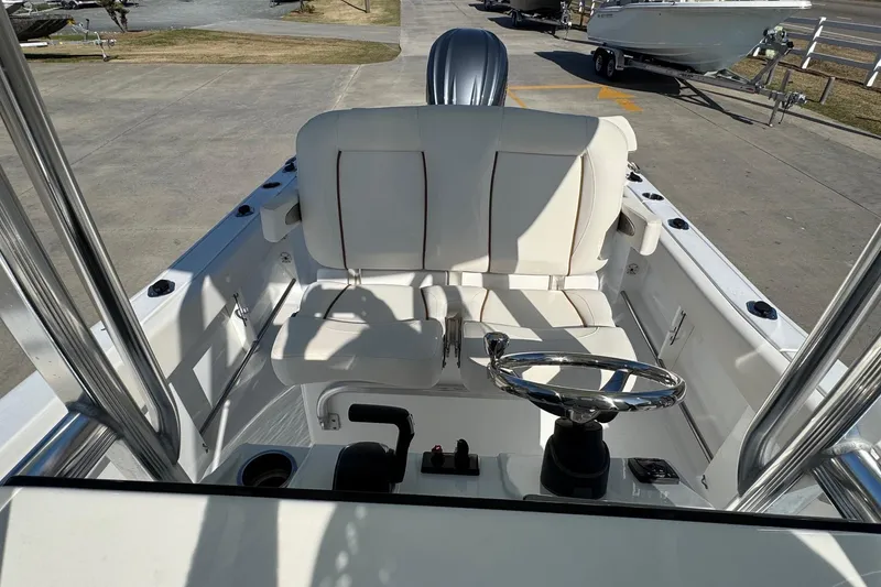 Slide: The Image of 2023 Sea Hunt Ultra 234 boat interior with steering wheel and seating. - 16