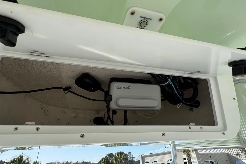 Slide: The Image of 2023 Sea Hunt Ultra 234 boat compartment with Garmin electronics and wiring. - 18