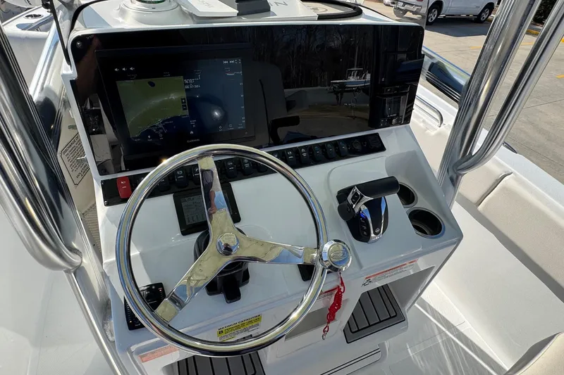 Slide: The Image of 2023 Sea Hunt Ultra 234 boat console with steering wheel and navigation display. - 19