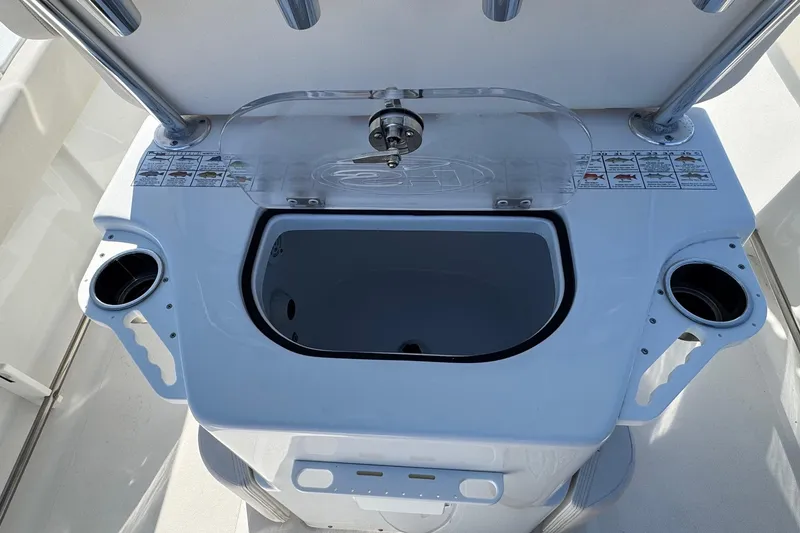 Slide: The Image of 2023 Sea Hunt Ultra 234 boat console with cup holders and storage compartment. - 23