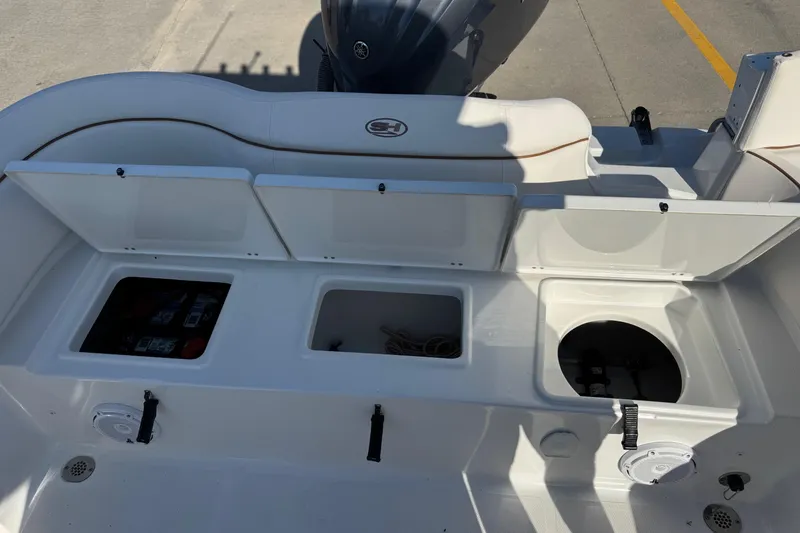 Slide: The Image of 2023 Sea Hunt Ultra 234 boat storage compartments and seating area. - 24