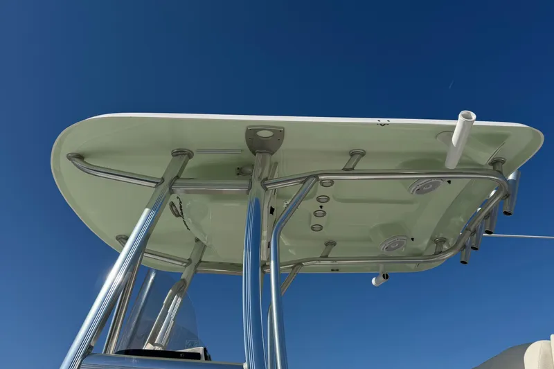 Slide: The Image of 2023 Sea Hunt Ultra 234 boat T-top against clear blue sky. - 25