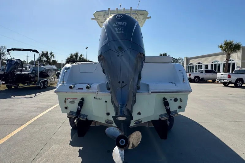 Slide: The Image of 2023 Sea Hunt Ultra 234 boat with Yamaha 250 V6 engine, parked outdoors. - 4