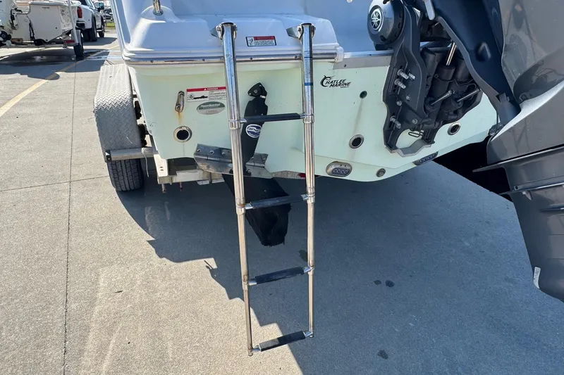 Slide: The Image of 2023 Sea Hunt Ultra 234 boat with ladder and outboard motor on trailer. - 7