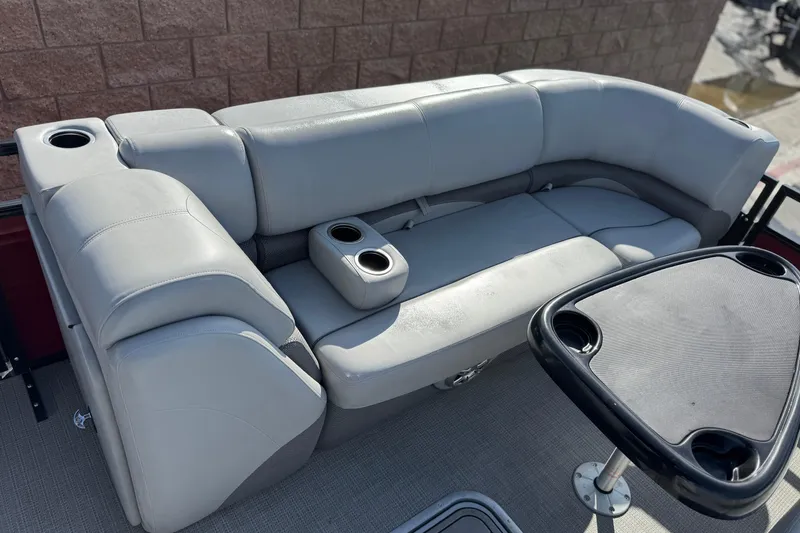 Slide: The Image of 2023 Regency 250 DL3 boat interior with gray seating and cup holders. - 11