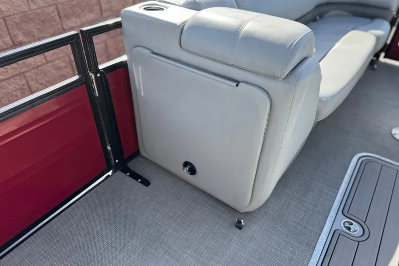 Slide: The Image of 2023 Regency 250 DL3 boat interior with beige seating and red paneling. - 16