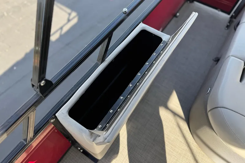 Slide: The Image of 2023 Regency 250 DL3 boat storage compartment with open lid, showcasing interior space. - 21